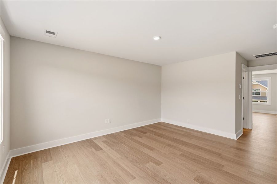 A naturally illuminated room boasts wide plank woo