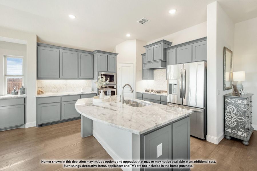 Kitchen with gray cabinets, marble island with sink, stainless steel refrigerator, and hardwood floors Kitchen with gray cabinets, marble island with sink, stainless steel refrigerator, and hardwood floors