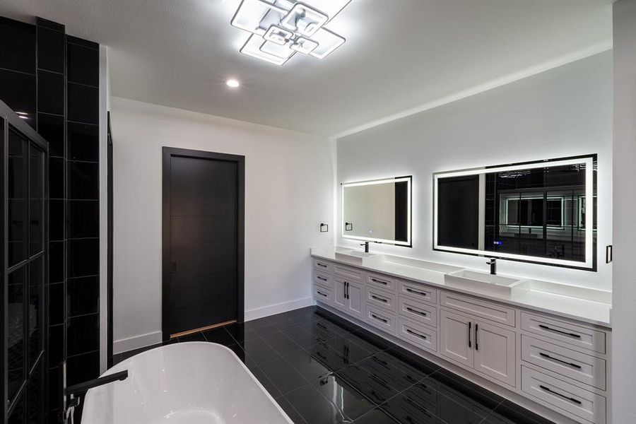 Bathroom with vanity, tile patterned floors, and a tub to relax in