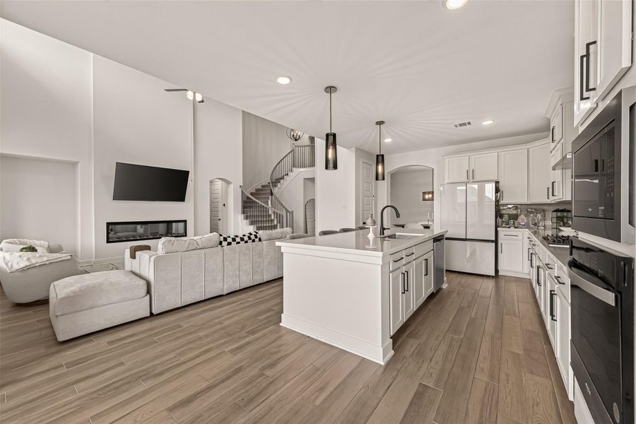 The gourmet kitchen features quartz countertops, ample cabinetry, and a large center island. The gourmet kitchen features quartz countertops, ample cabinetry, and a large center island.