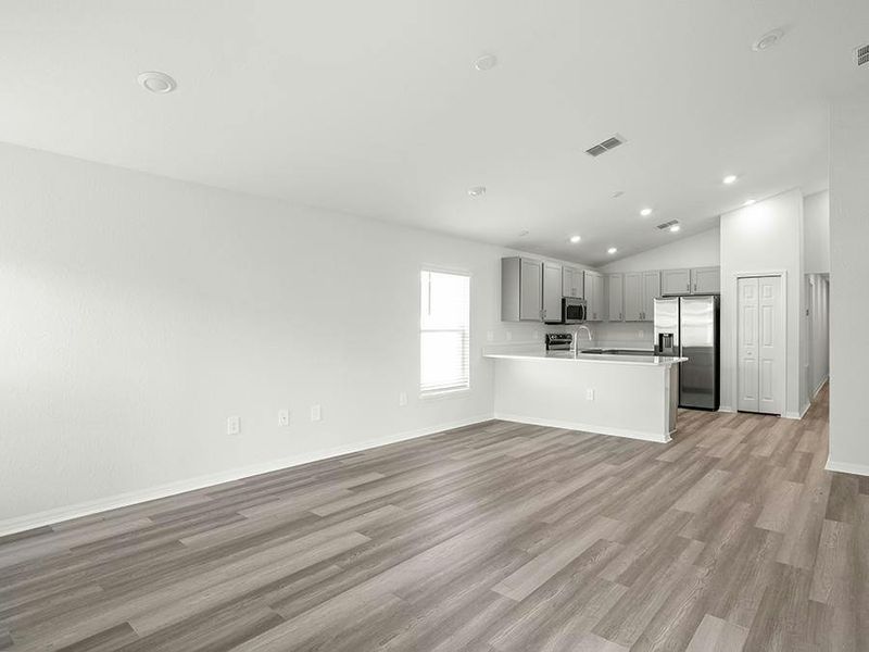 Enjoy an open living area with airy volume ceilings and low-maintenance LVP flooring.