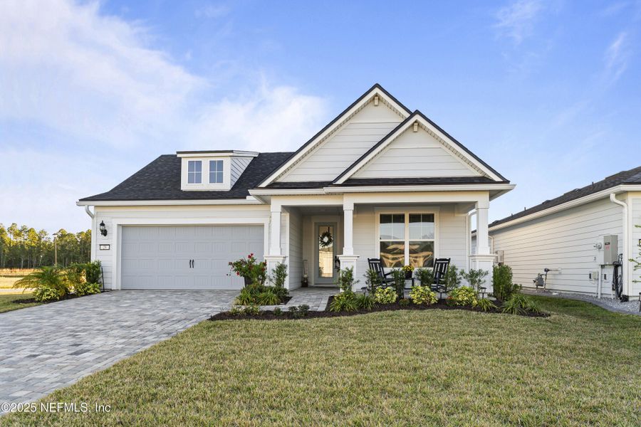 Front exterior of a new home in Summer Bay at Grand Oaks, St. Augustine, FL, highlighting curb appeal (Image 2).