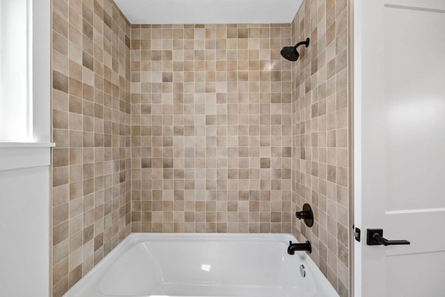 Full bath featuring shower / washtub combination