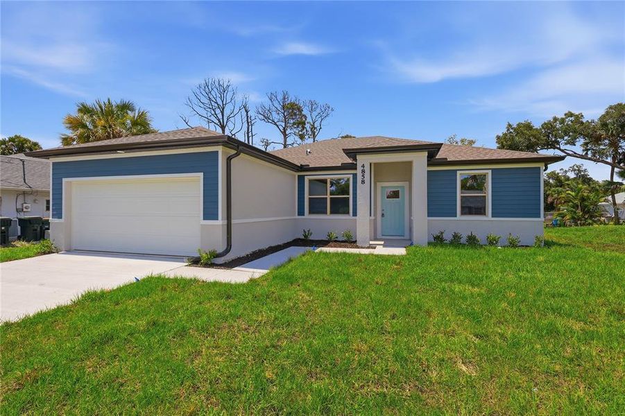 Front exterior of a new home in , North Port, FL, highlighting curb appeal (Image 2). Front exterior of a new home in , North Port, FL, highlighting curb appeal (Image 2).