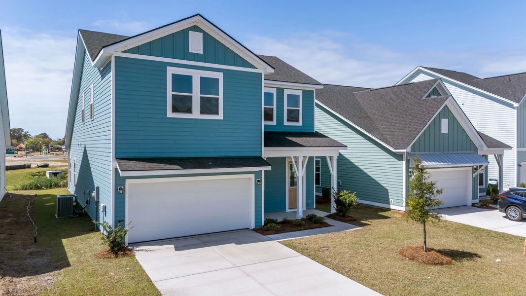 Front exterior of a new home in Blue Heron Retreat, Little River, SC, highlighting curb appeal (Image 2). Front exterior of a new home in Blue Heron Retreat, Little River, SC, highlighting curb appeal (Image 2).