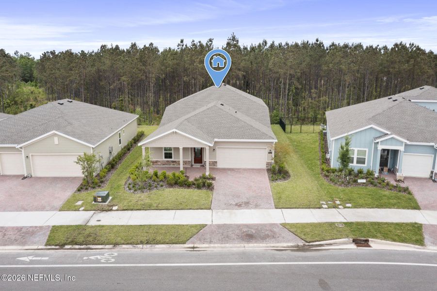 Front exterior of a new home in Tributary, Yulee, FL, highlighting curb appeal (Image 20). Front exterior of a new home in Tributary, Yulee, FL, highlighting curb appeal (Image 20).