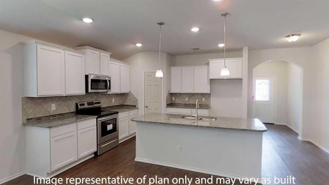 Kitchen with light stone countertops, stainless steel appliances, backsplash, arched walkways, and white cabinetry Kitchen with light stone countertops, stainless steel appliances, backsplash, arched walkways, and white cabinetry