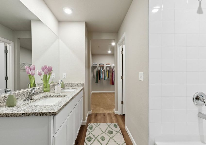 The master bathroom has a large vanity and a step in shower