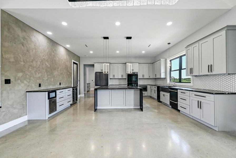 Incredible cabinetry storage with custom designed cabinetry including a built-in dry bar buffet with a wine fridge and an ice maker. Incredible cabinetry storage with custom designed cabinetry including a built-in dry bar buffet with a wine fridge and an ice maker.