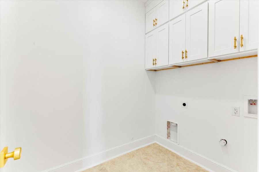 Laundry room with built-in cabinetry for added storage and convenience. Laundry room with built-in cabinetry for added storage and convenience.