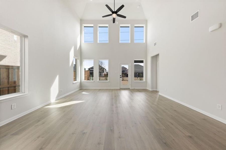 Your spacious new family room is flooded with natural light from a dual stacked wall of windows!