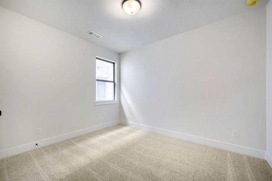 Neutral-toned carpeting paired with crisp white walls and baseboards Neutral-toned carpeting paired with crisp white walls and baseboards