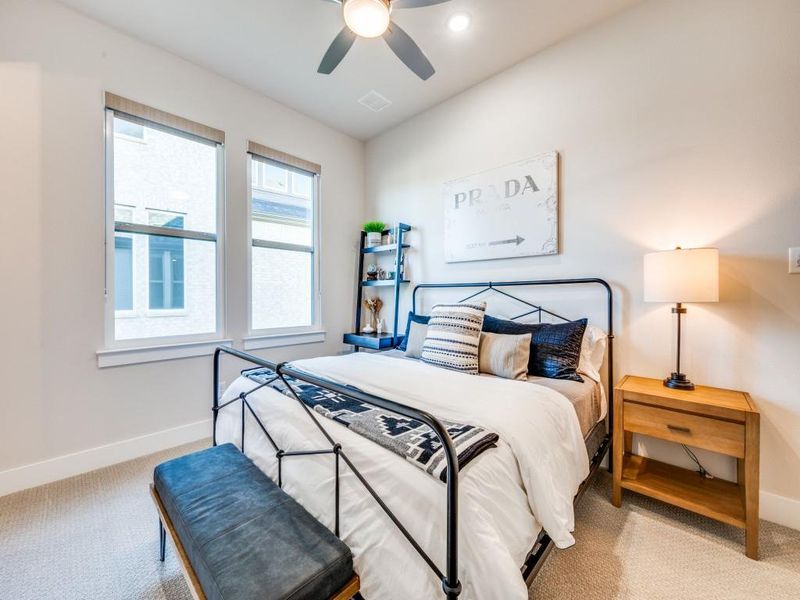 Carpeted bedroom with baseboards and ceiling fan