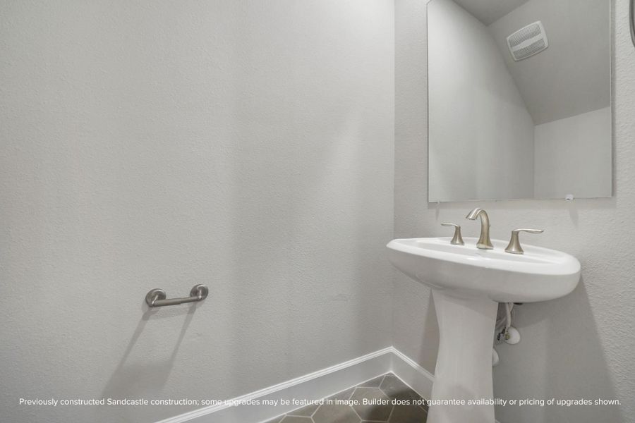 Tucked away with intention, this powder room pairs brushed nickel finishes with refined design—elegant enough for guests, practical for every day.