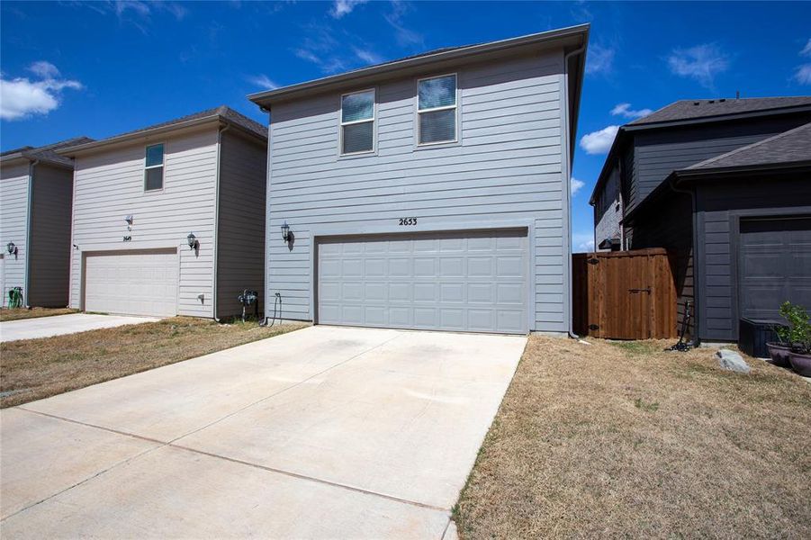 View of front of home featuring a garage and driveway