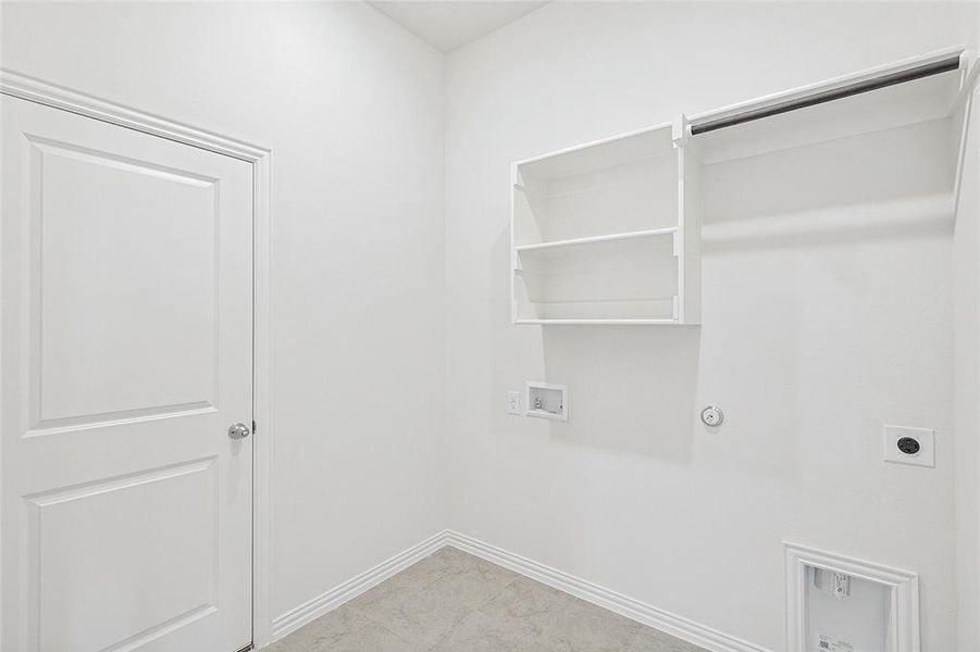 Laundry area with gas dryer hookup, washer hookup, and hookup for an electric dryer