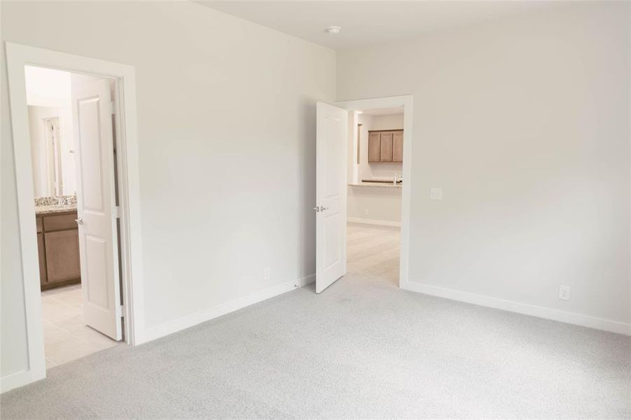 Empty room featuring light colored carpet