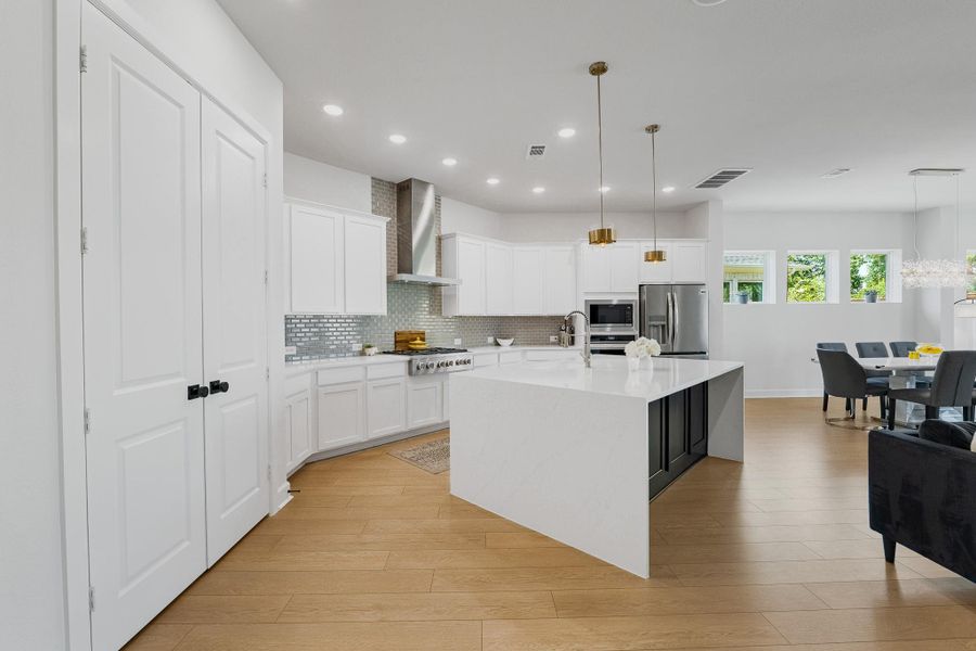 Large kitchen w/custom island w/waterfall edge.