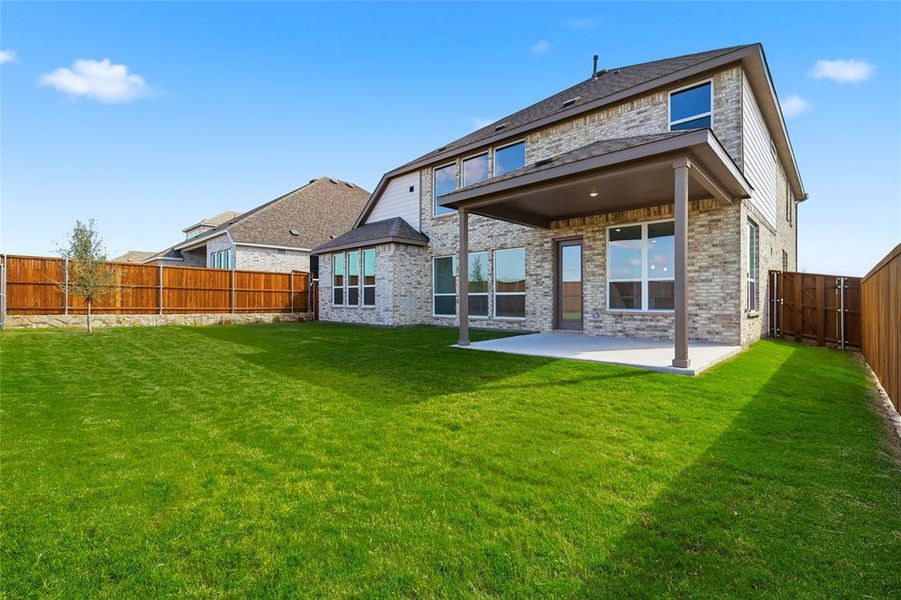 Rear view of property with a patio, brick siding, and a fenced backyard Rear view of property with a patio, brick siding, and a fenced backyard