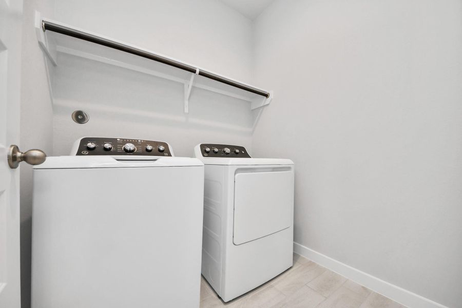 A perfect blend of functionality and comfort. Capture the essence of easy living with a first-floor laundry room, thoughtfully equipped with shelving for effortless organization. Both electric and gas connections available. Sample photo of completed home with similar floor plan. Actual colors and selections may vary. A perfect blend of functionality and comfort. Capture the essence of easy living with a first-floor laundry room, thoughtfully equipped with shelving for effortless organization. Both electric and gas connections available. Sample photo of completed home with similar floor plan. Actual colors and selections may vary.