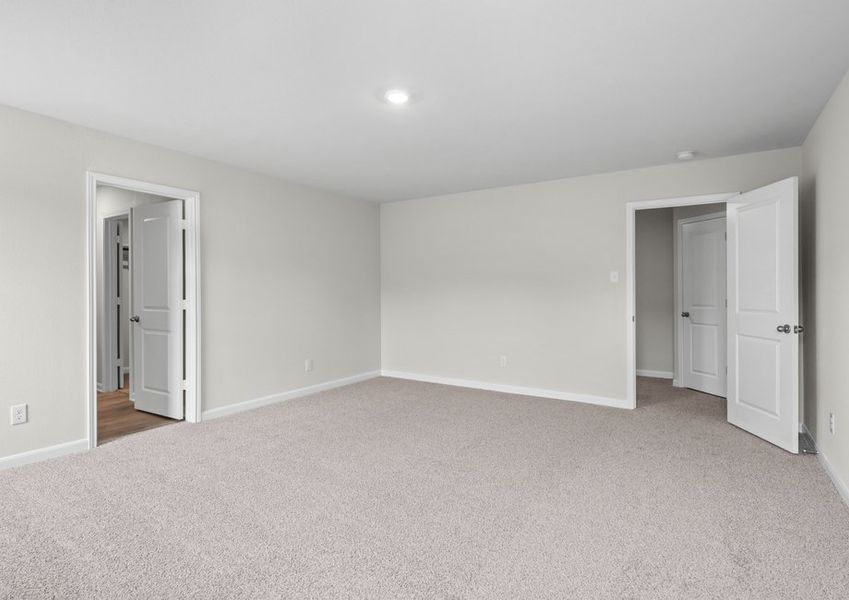 The master suite has a large bedroom, ensuite bathroom and a walk-in closet.