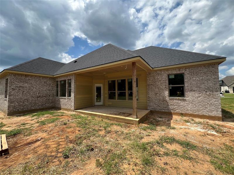 Rear view of house featuring a patio