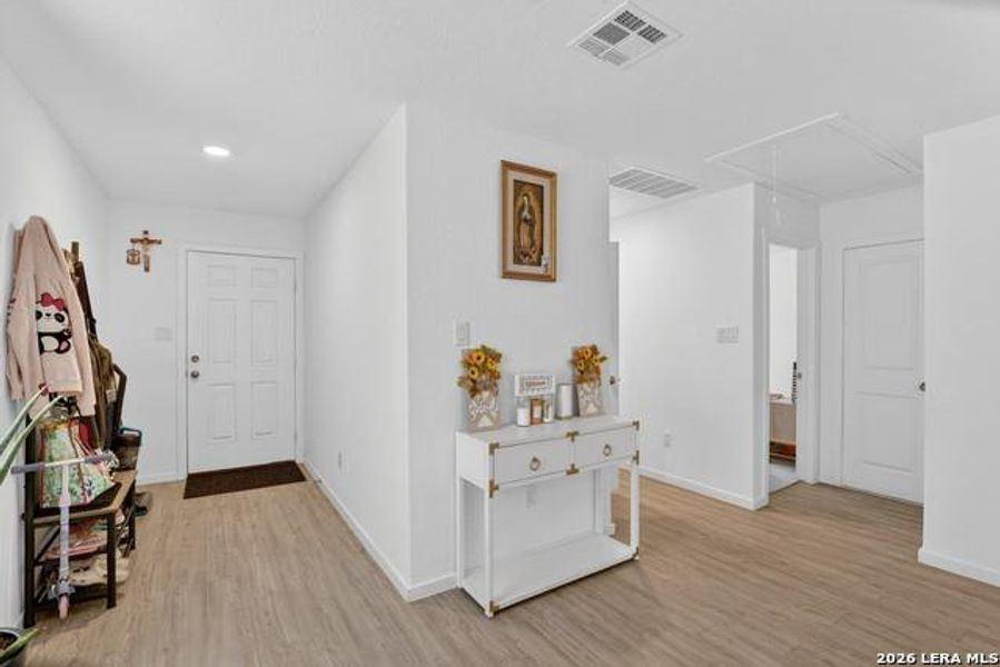 A welcoming entryway with durable plank flooring sets a practical tone for daily living. A welcoming entryway with durable plank flooring sets a practical tone for daily living.