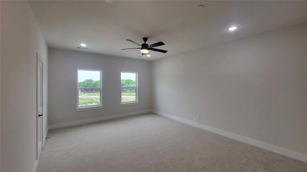 Unfurnished room with light carpet, visible vents, baseboards, recessed lighting, and ceiling fan