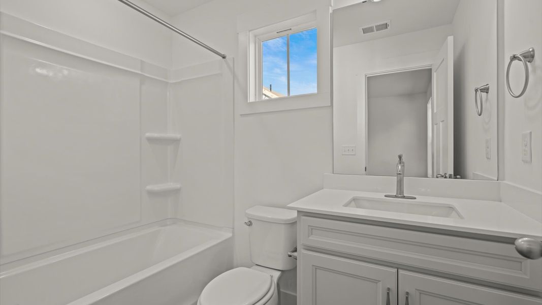 Vibrant and welcoming bathroom with elegant countertop space and polished details