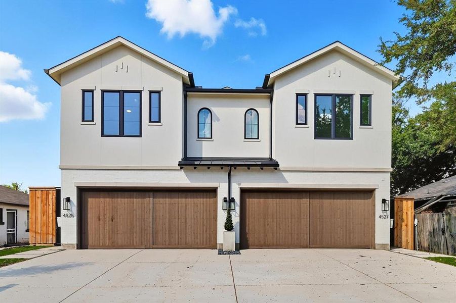 View of front facade with stucco siding, driveway, and an attached garage View of front facade with stucco siding, driveway, and an attached garage