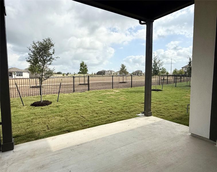Fenced backyard with a patio area Fenced backyard with a patio area
