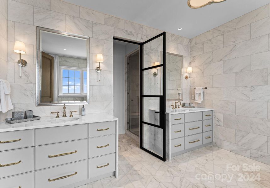 Upper-level secondary En-suite features two vanities, a soaker tub, and a separate shower room.