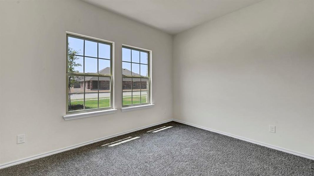 Interior room with light gray walls and dark gray carpet