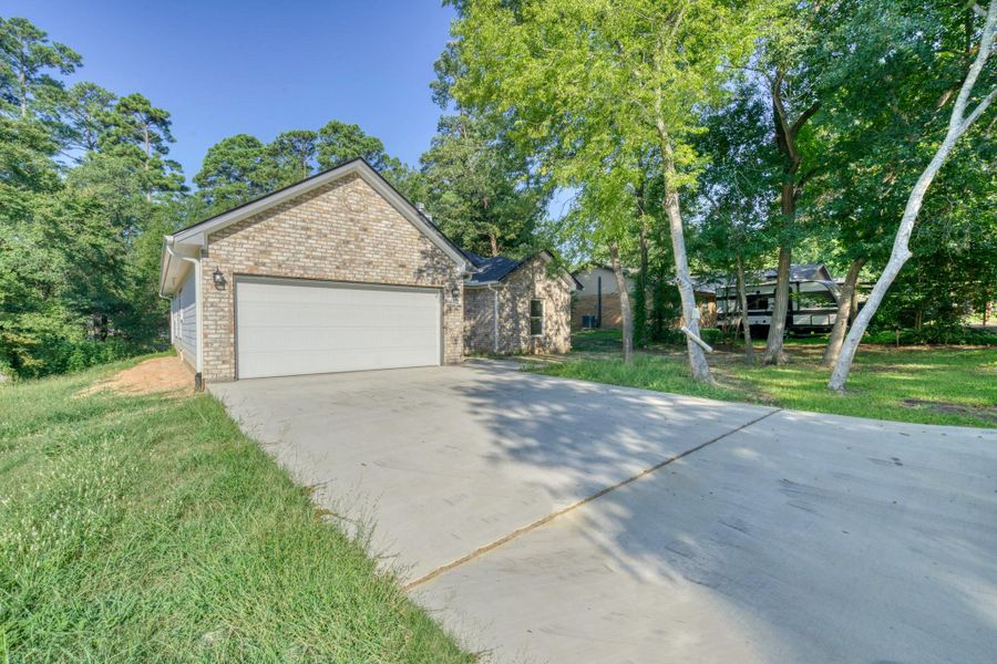 Front exterior of a new home in , Huntsville, TX, highlighting curb appeal (Image 2). Front exterior of a new home in , Huntsville, TX, highlighting curb appeal (Image 2).