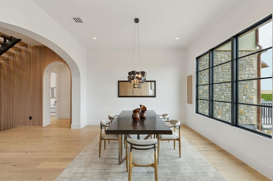 Dining space featuring plenty of natural light, white oak wood floors, a designer lighting, and recessed lighting Dining space featuring plenty of natural light, white oak wood floors, a designer lighting, and recessed lighting