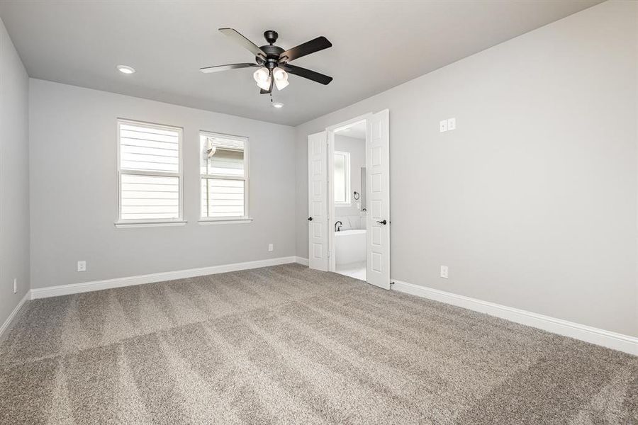 Empty room with carpet, ceiling fan, and recessed lighting