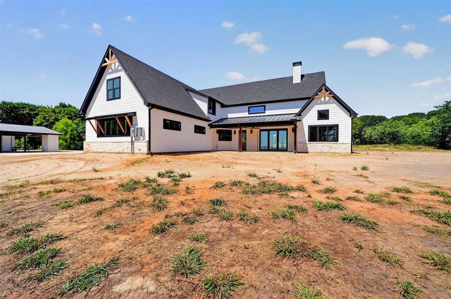 Stunning rear exterior view showcasing the walls of windows. Stunning rear exterior view showcasing the walls of windows.