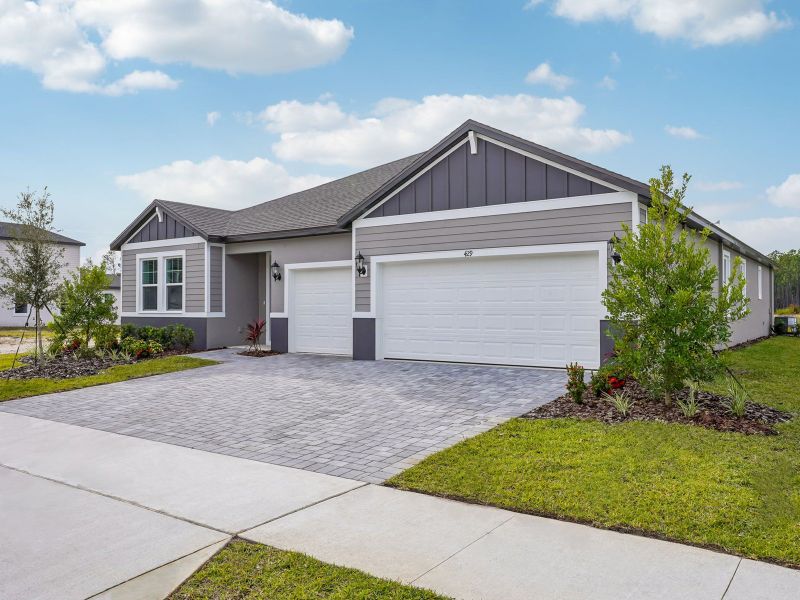Front exterior of a new home in Ridgehaven - Reserve Series, Ormond Beach, FL, highlighting curb appeal (Image 1).