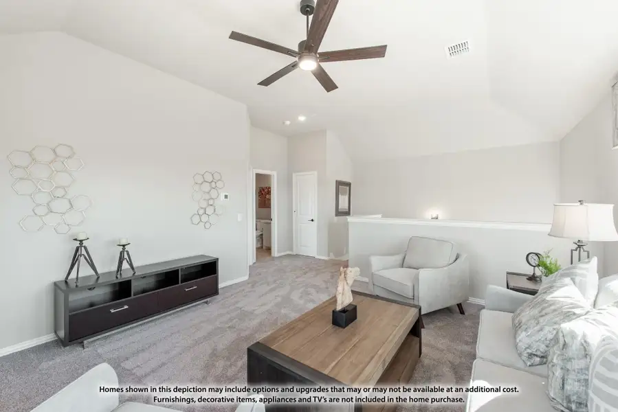 Upstairs living area with vaulted ceiling, ceiling fan, carpet, and neutral gray furniture