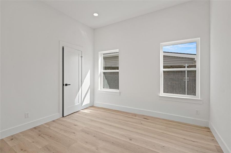 Spare room with light wood-style floors and recessed lighting