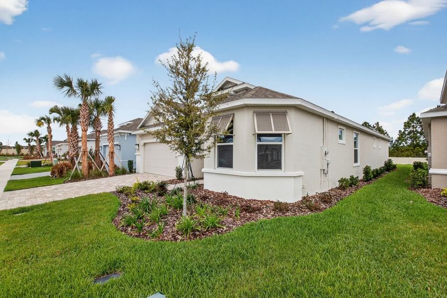 Front exterior of a new home in Center Lake Ranch Community Group Page, St. Cloud, FL, highlighting curb appeal (Image 2). Front exterior of a new home in Center Lake Ranch Community Group Page, St. Cloud, FL, highlighting curb appeal (Image 2).