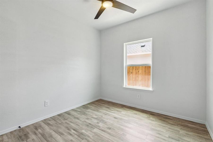 Empty room featuring ceiling fan and light hardwood / wood-style floors