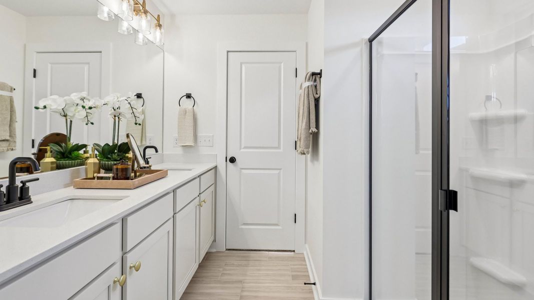 Bathroom with dual vanity and glass enclosed shower Bathroom with dual vanity and glass enclosed shower