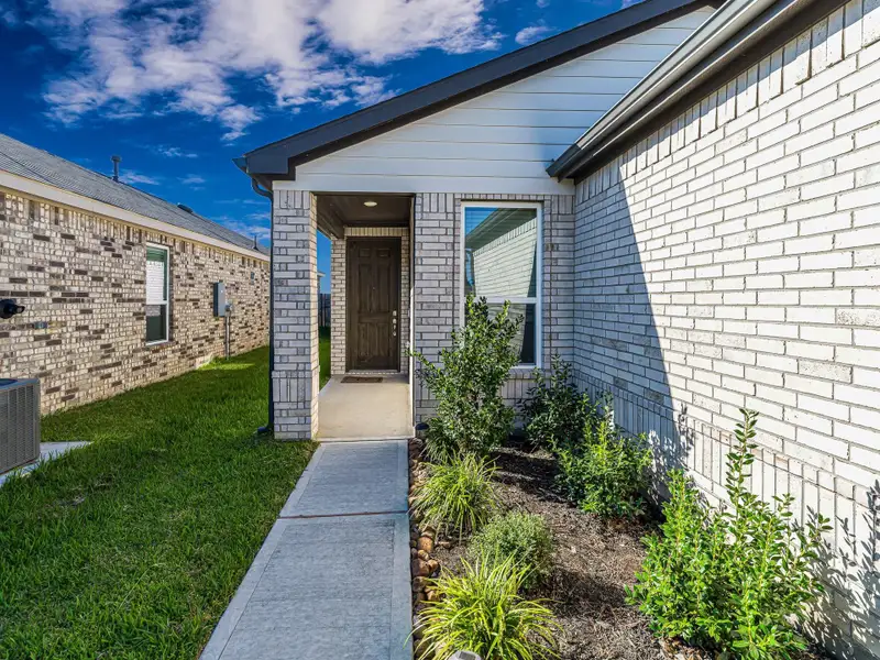 Covered front porch and tall wood front door with smart lock. Covered front porch and tall wood front door with smart lock.