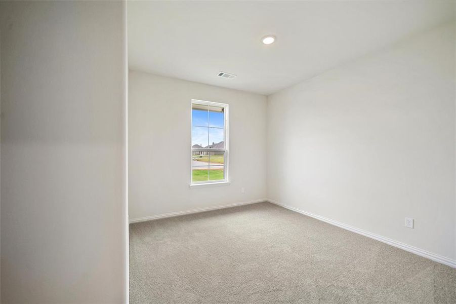 Spare room featuring light carpet and recessed lighting