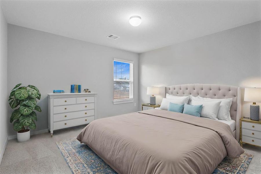 Secondary bedroom features plush carpet, custom paint, high ceilings, and a large window with privacy blinds.