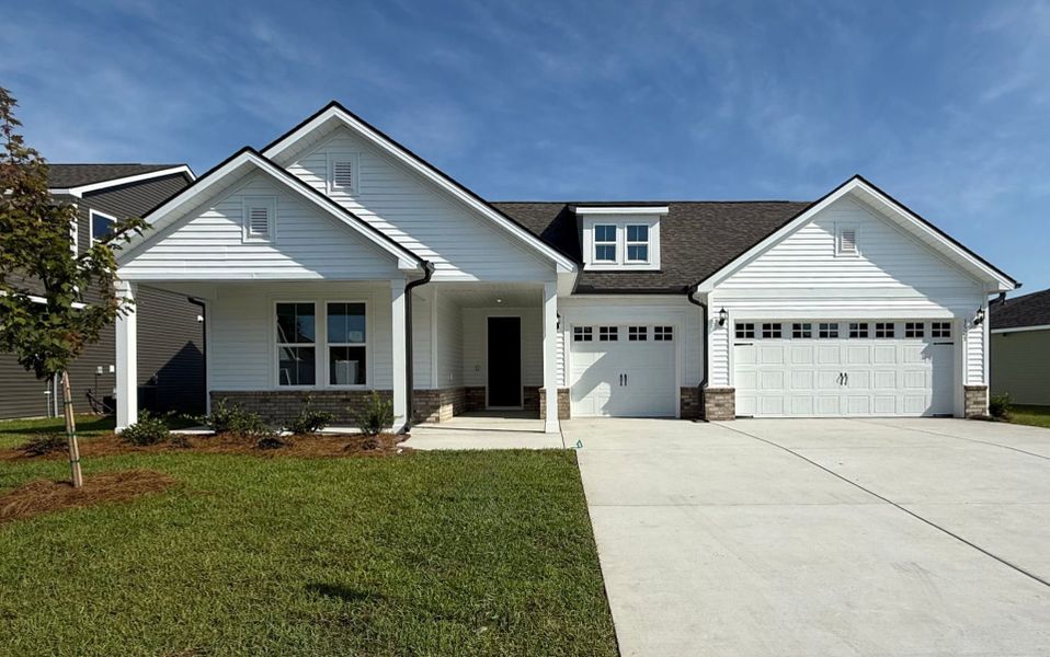 Front exterior of a new home in Crescent Cove, Myrtle Beach, SC, highlighting curb appeal (Image 22). Front exterior of a new home in Crescent Cove, Myrtle Beach, SC, highlighting curb appeal (Image 22).