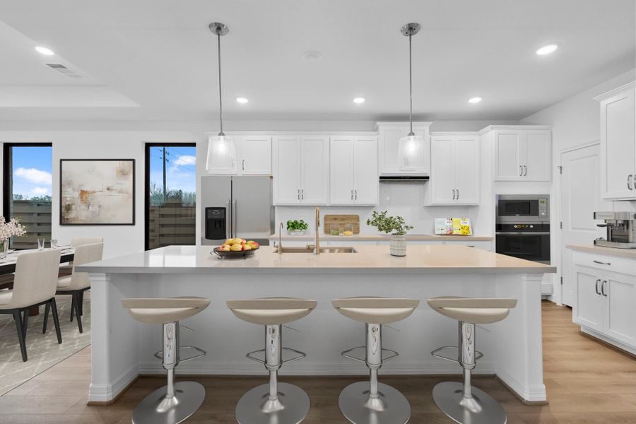 Kitchen featuring the AW Collection Timeless with classic white cabinetry, quartz countertops, and a herringbone tile backsplash. It's design fit for any era. Kitchen featuring the AW Collection Timeless with classic white cabinetry, quartz countertops, and a herringbone tile backsplash. It's design fit for any era.
