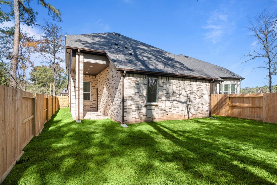 Exterior details and patio area of a home in The Woodlands Hills, Willis (Image 3).