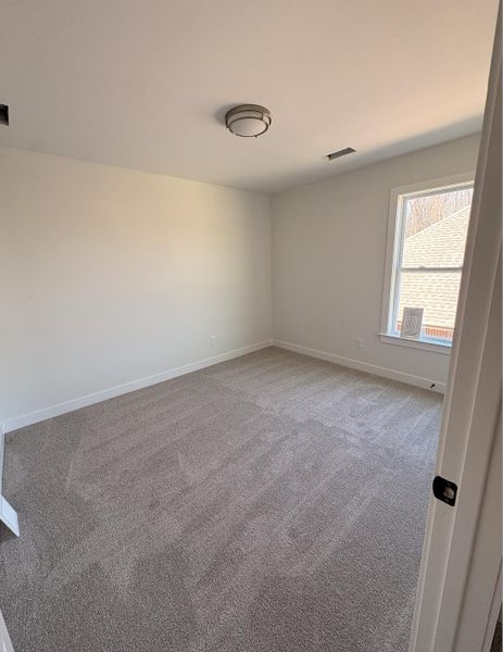 Empty room with carpet flooring and baseboards